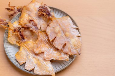 Dried squid snack in the plate