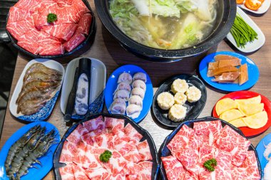 Sliced of beef and food on table in restaurant
