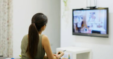 Kadınlar evde televizyon izler.