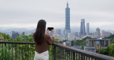 Woman take photo on the Taipei city
