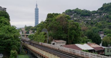 Taipei, Taiwan - 18 April 2022: Metro train track Taipei 101 skyline 