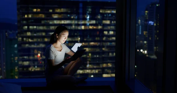 Woman look at the tablet computer in the evening