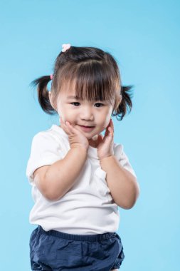 Little girl touch her face