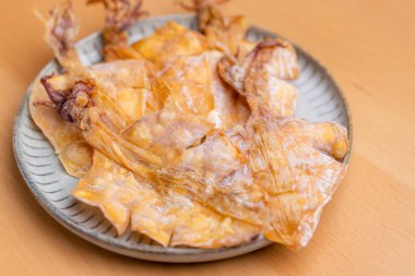 Dried squid snack in the plate