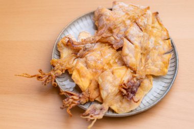 Dried squid snack in the plate