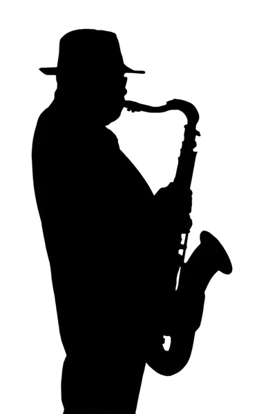 Silhouette del musicista che suona su un sassofono . Immagini Stock Royalty Free