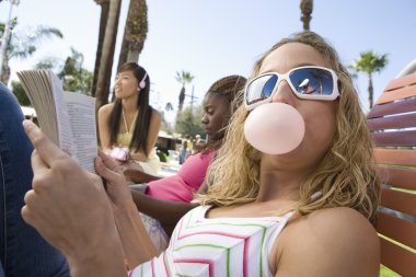 woman blowing bubble gum