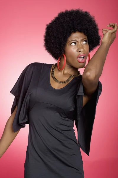 Dancing young woman over colored background — Stock Photo, Image