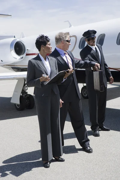 Businessman Taking Briefcase From Driver At Airfield — Stock Photo, Image