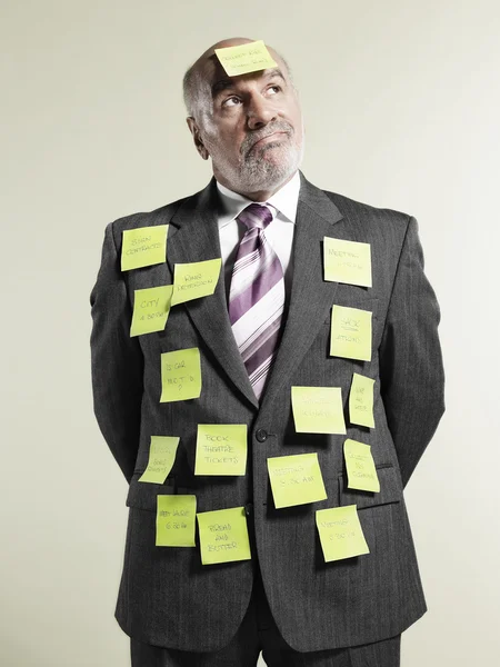 Empresário coberto com notas adesivas — Fotografia de Stock