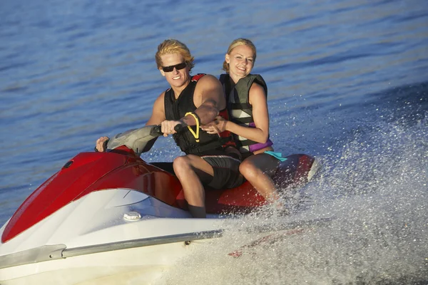 Pareja joven montando PWC en el lago —  Fotos de Stock