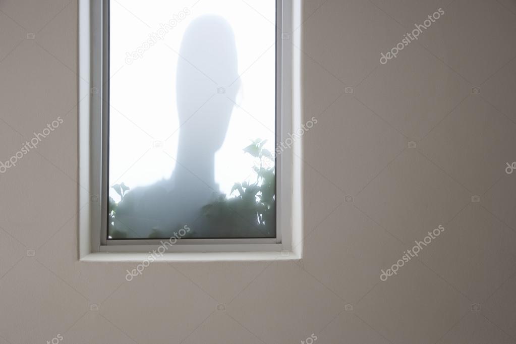 Shadow Of A Man Behind Window