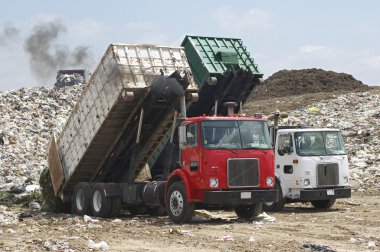 Truck with garbage at dump  clipart