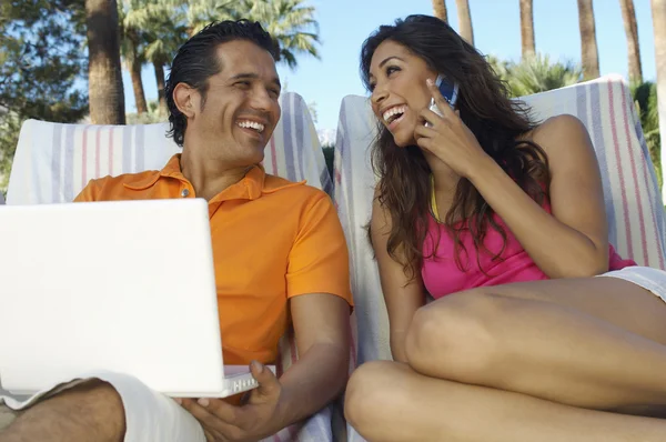 Couple Using Laptop And Mobile Phone — Stock Photo, Image