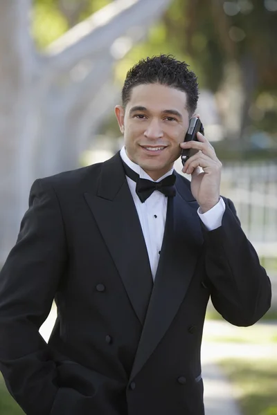 Young Man In Tuxedo Using Cell Phone at Quinceanera — Stock Photo, Image