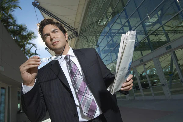 Businessman With Newspaper Outside Office — Stock Photo, Image