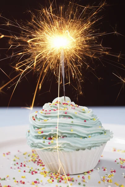 Party cupcake with lit sparkler — Stock Photo, Image