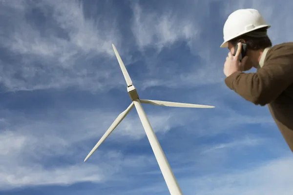 Engineer Using Mobile Phone At Wind Farm — Stock Photo, Image