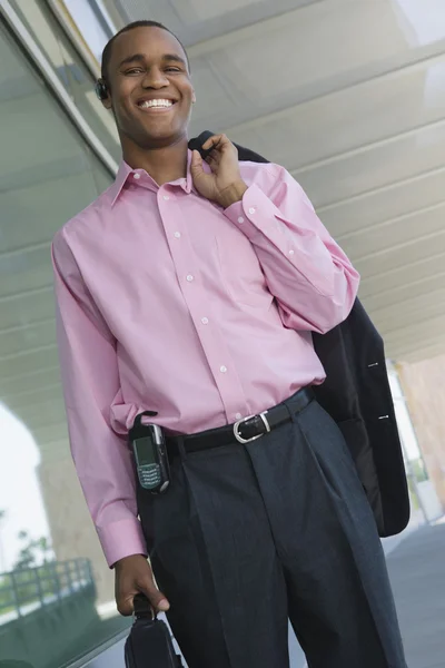 Businessman Holding Coat Over Shoulder Stock Image