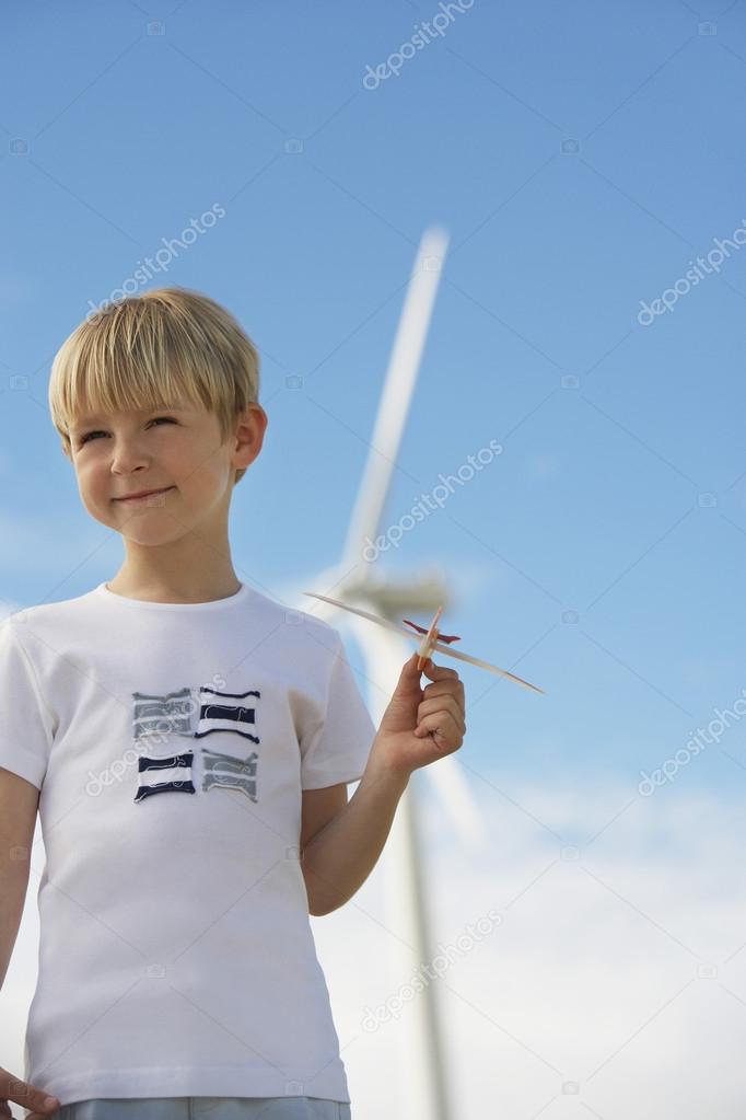 Boy With Toy Glider At Wind Farm