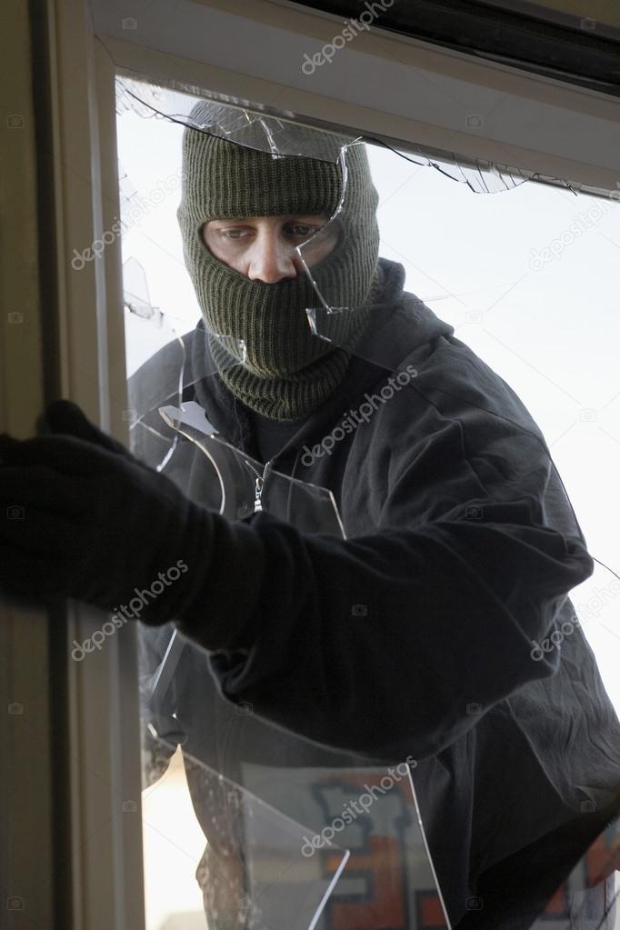 Masked Thief Breaking In Through Window