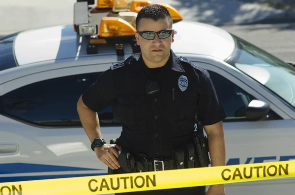 Police Officer Standing Behind Caution Tape — Stock Photo, Image