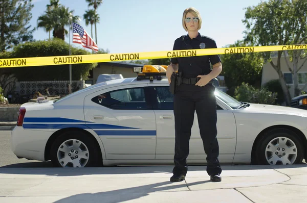 Police Officer Standing Behind Caution Tape — Stock Photo, Image