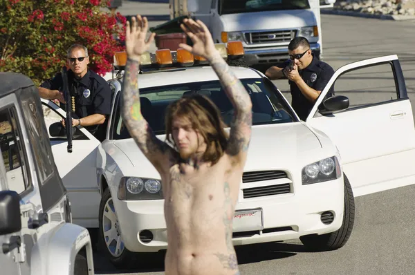 Police Officer Arresting Young Man — Stock Photo, Image