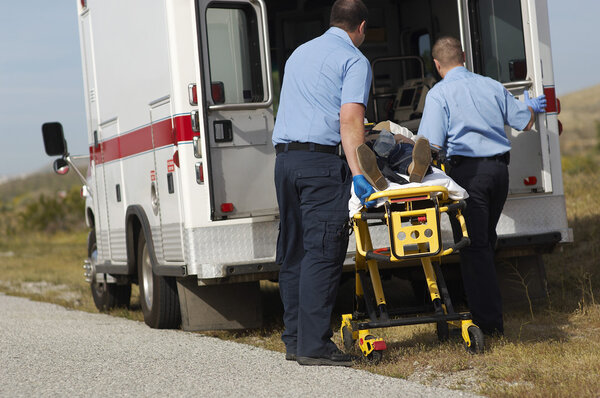 Paramedics With Victim On Stretcher