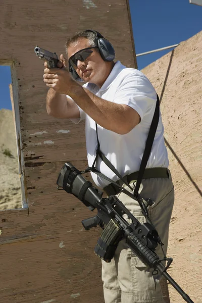 Homme visant pistolet à main au champ de tir — Photo