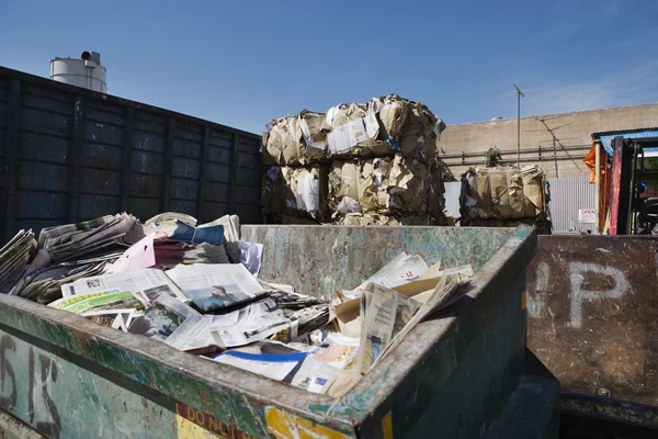 Thrown Newspapers With Stacked Cardboard Boxes — Stock Photo, Image