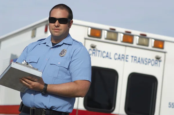 Paramedic In Front Of Ambulance Stock Photo