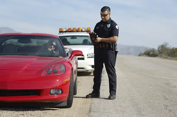 Traffic Cop By Sports Car Stock Photo