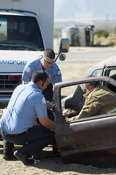 Firefighter And Paramedics At Crash Scene Royalty Free Stock Images