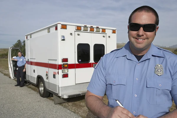 Paramedic In Front Of Ambulance Royalty Free Stock Images