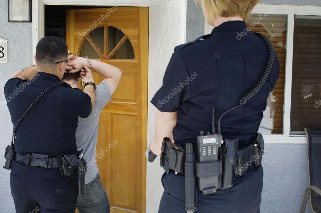 Police Officer Arresting Young Man Stock Photo by ©londondeposit 21800509