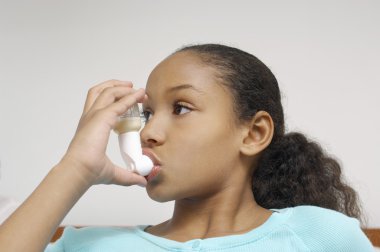 Girl Using Asthma Inhaler clipart