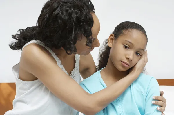 Woman Comforting Sick Daughter — Stock Photo, Image