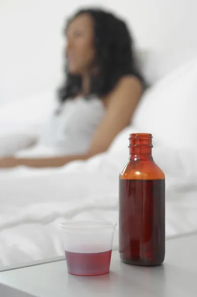 Cough Medicine In Front Of Sick Woman — Stock Photo, Image