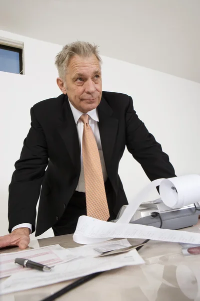 Businessman With Calculator Paper