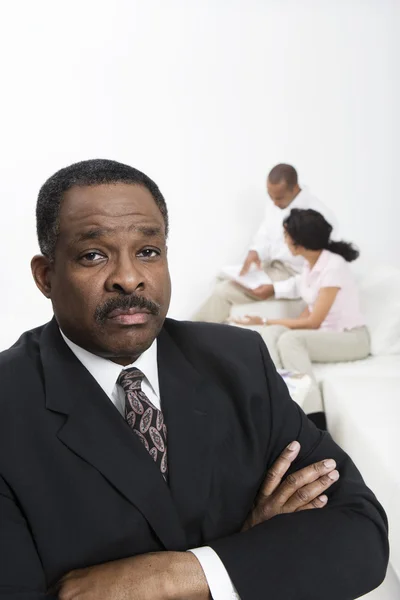 Accountant With Couple In Background — Stock Photo, Image