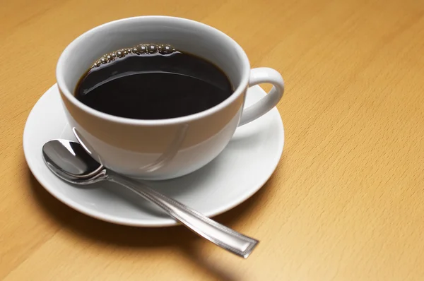 Kaffeetasse mit Löffel — Stockfoto