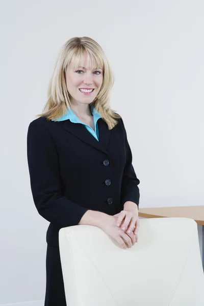 Businesswoman Standing Behind Chair — Stock Photo, Image