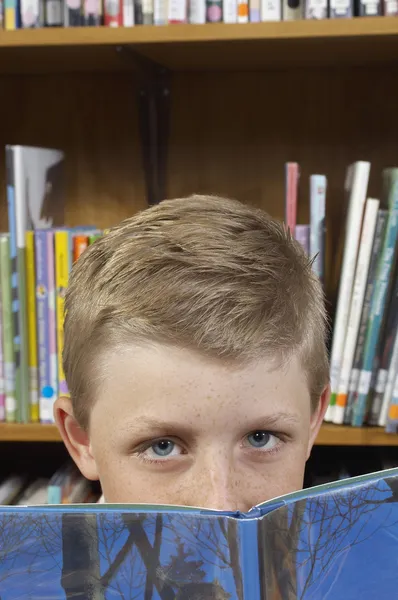 Boy Peeking Over Book — Stock Photo, Image