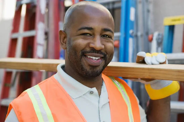 Construction Worker Holding Wooden Plank — Stock Photo, Image