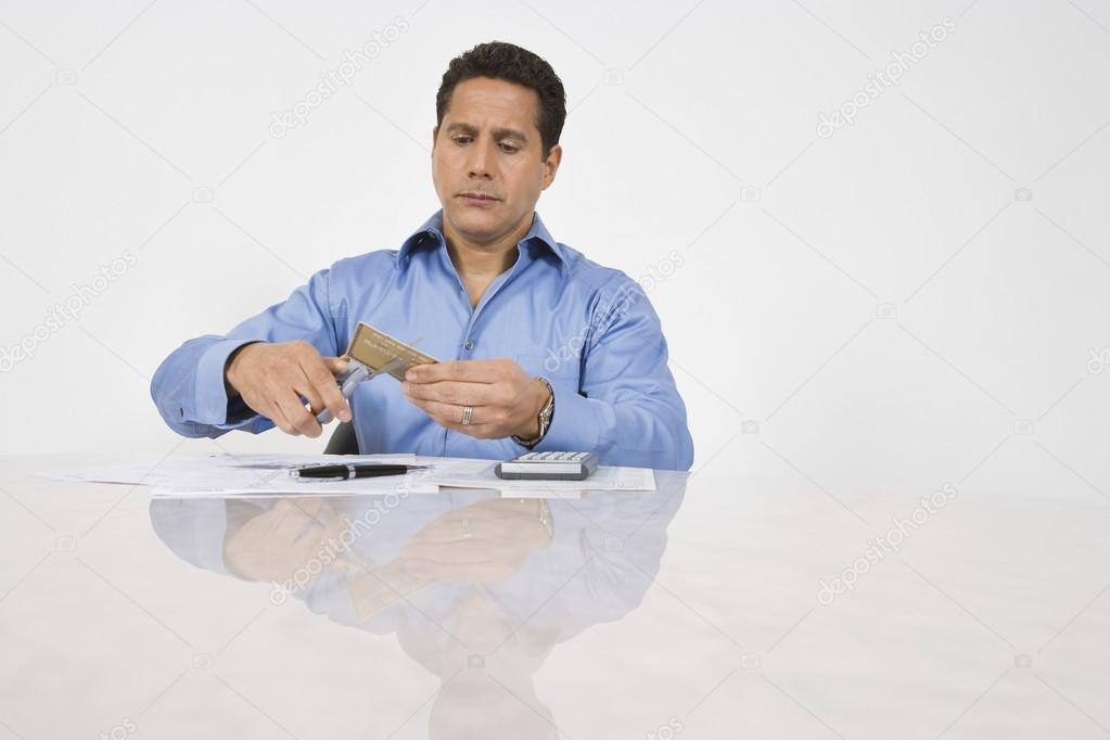 Man Cutting Up Credit Card