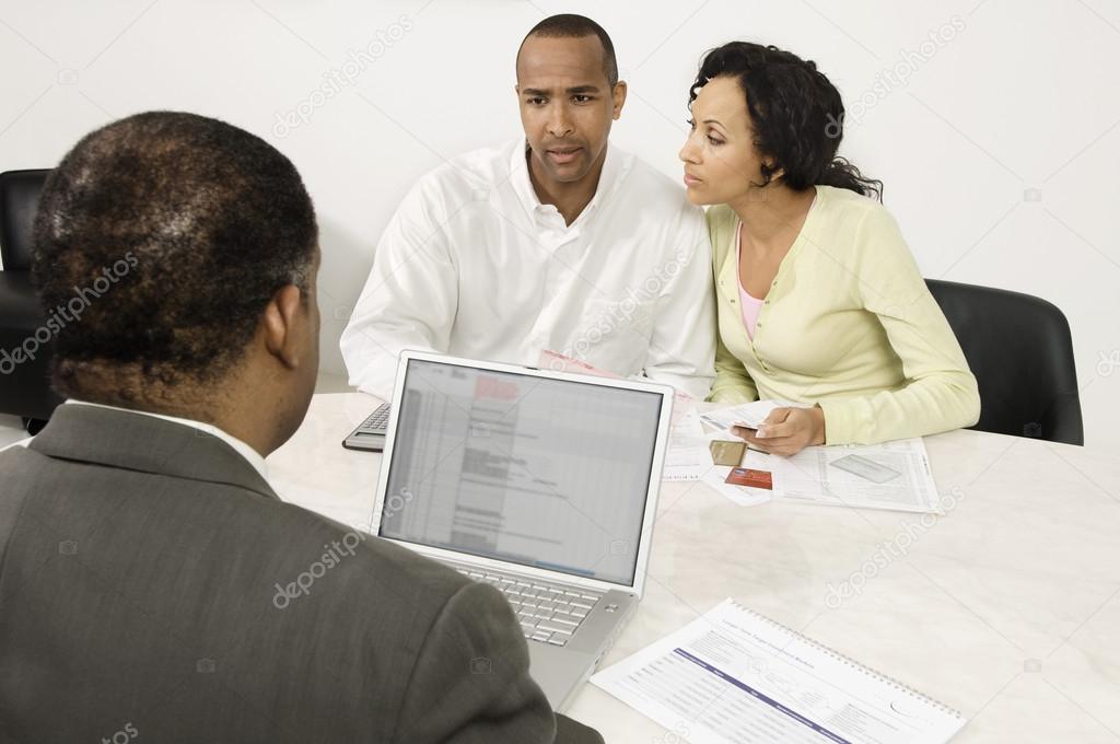 Couple Discussing Financial Plans With Male Advisor