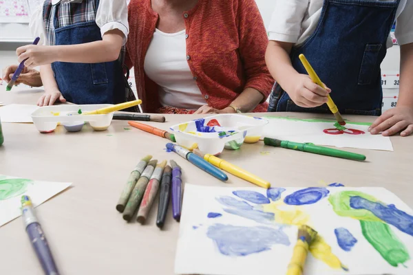 Lehrer beobachtet Schüler beim Malen — Stockfoto
