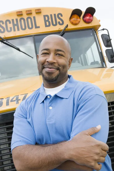 Teacher In Front Of School Bus