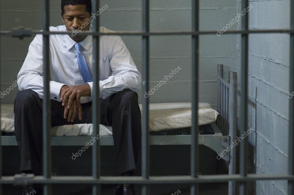 Businessman Sitting In Prison Cell — Stock Photo © londondeposit 21832611